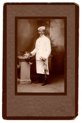 [An African American chef with fowl.]
