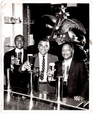 [Lot of photographs of an African American Budweiser representative.]